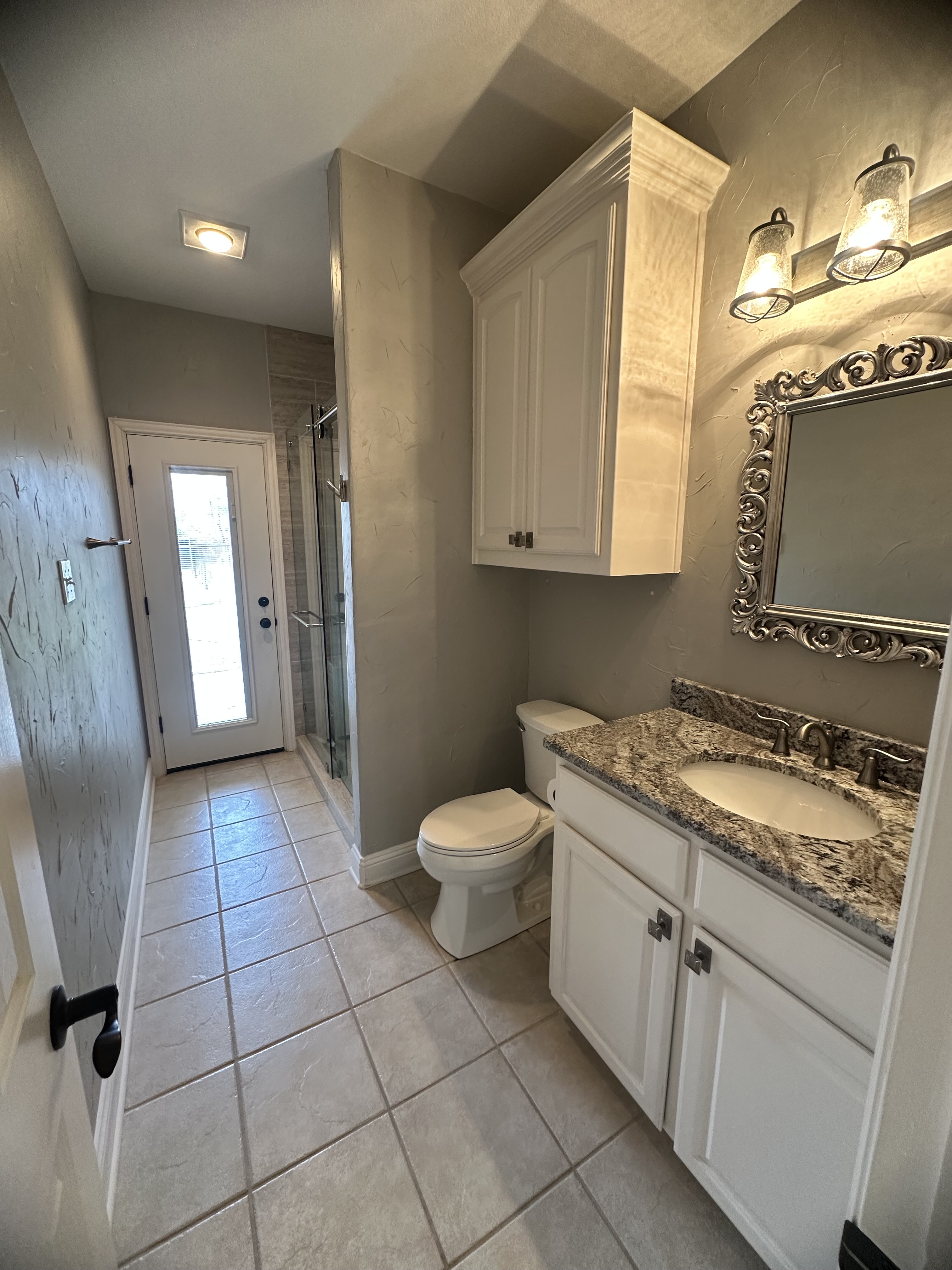 3588 Heritage Trail Celina, TX 75009 - Photo 13 of 19 a bathroom with a granite countertop sink a toilet and a mirror