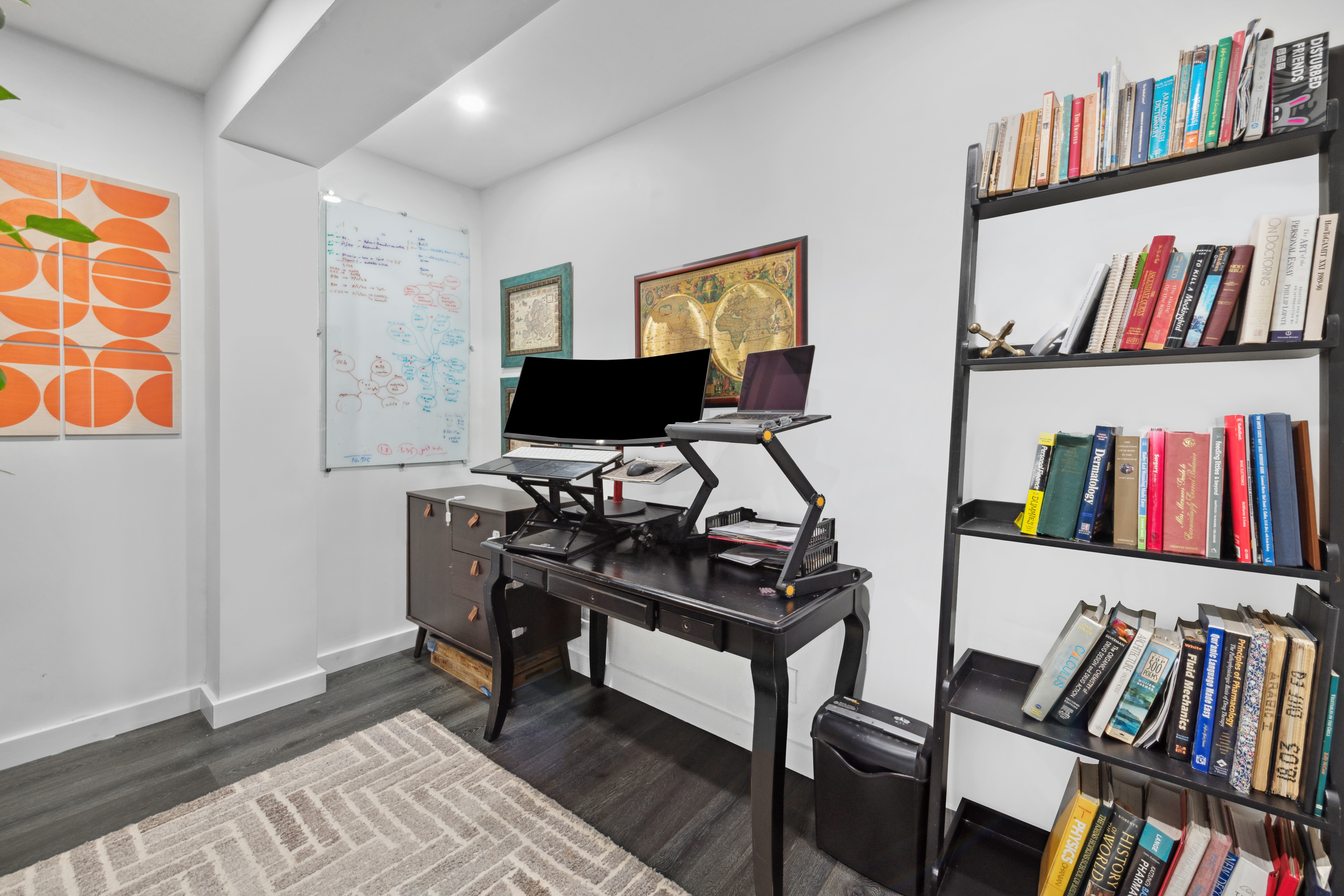 400 East 77th Street, Unit 1CD Manhattan, NY 10075 - Photo 10 of 18 a view of a workspace with furniture and a book shelf