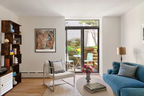 a living room with furniture and a floor to ceiling window