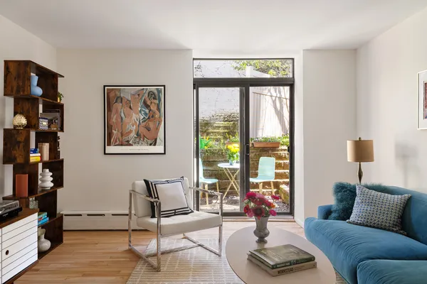 a living room with furniture and a floor to ceiling window