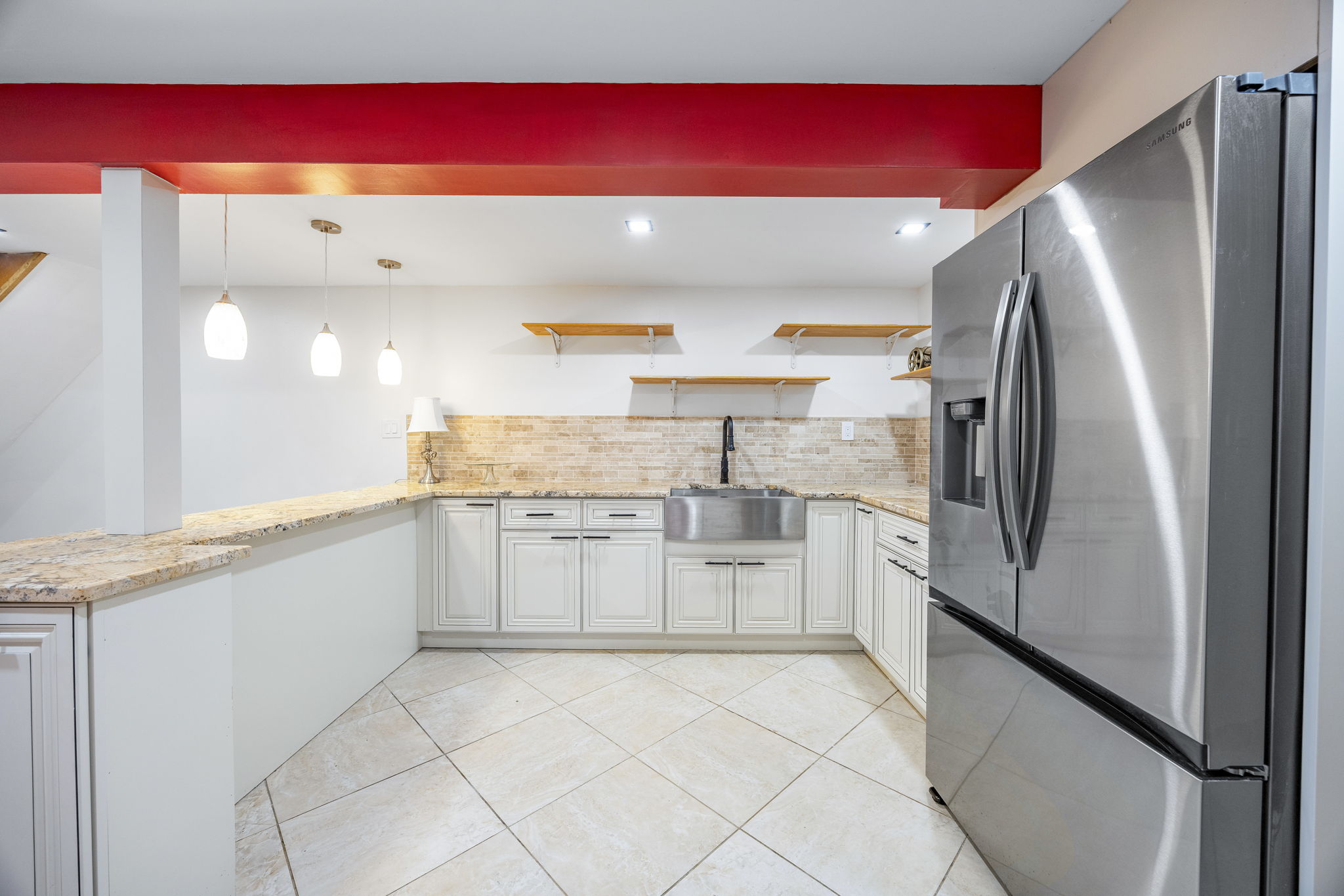 25-69 46th Street Queens, NY 11103 - Photo 28 of 33 a kitchen with granite countertop a refrigerator and a sink