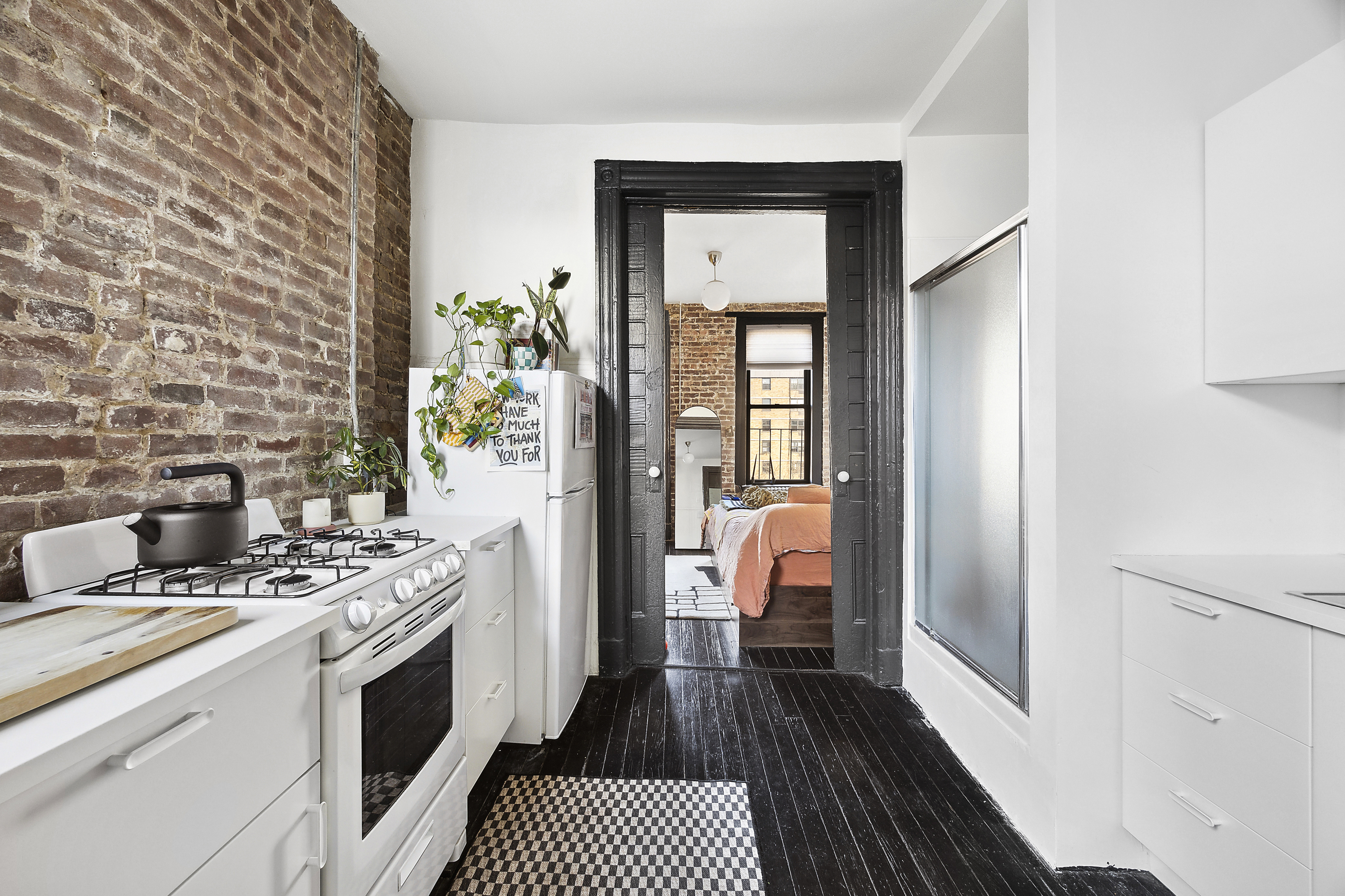 633 East 11th Street, Unit 23 Manhattan, NY 10009 - Photo 3 of 8 a kitchen with a refrigerator and a stove
