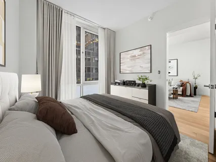 a bedroom with a bed and glass windows