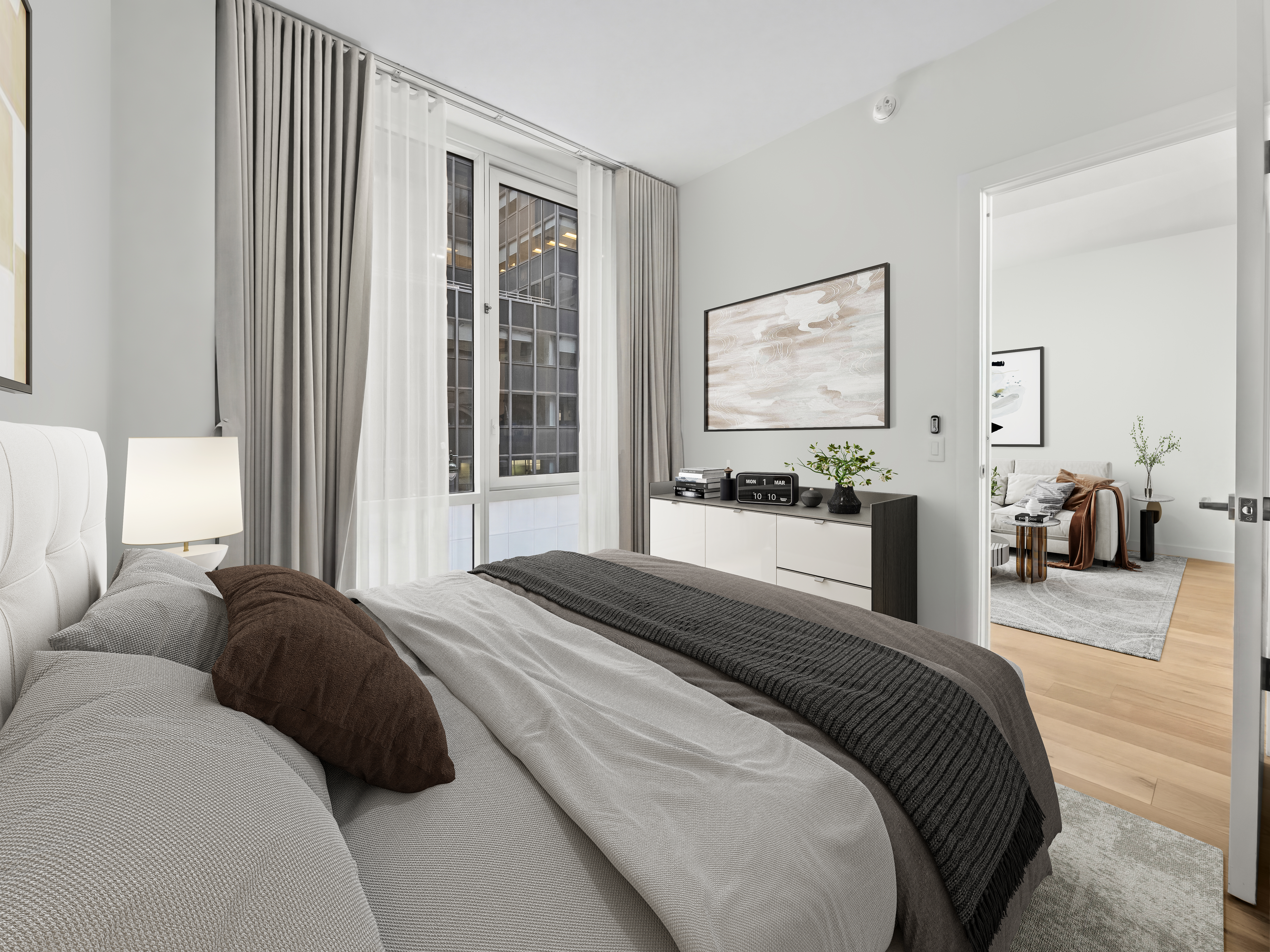135 East 47th Street, Unit 4F Manhattan, NY 10017 - Photo 5 of 11 a bedroom with a bed and glass windows