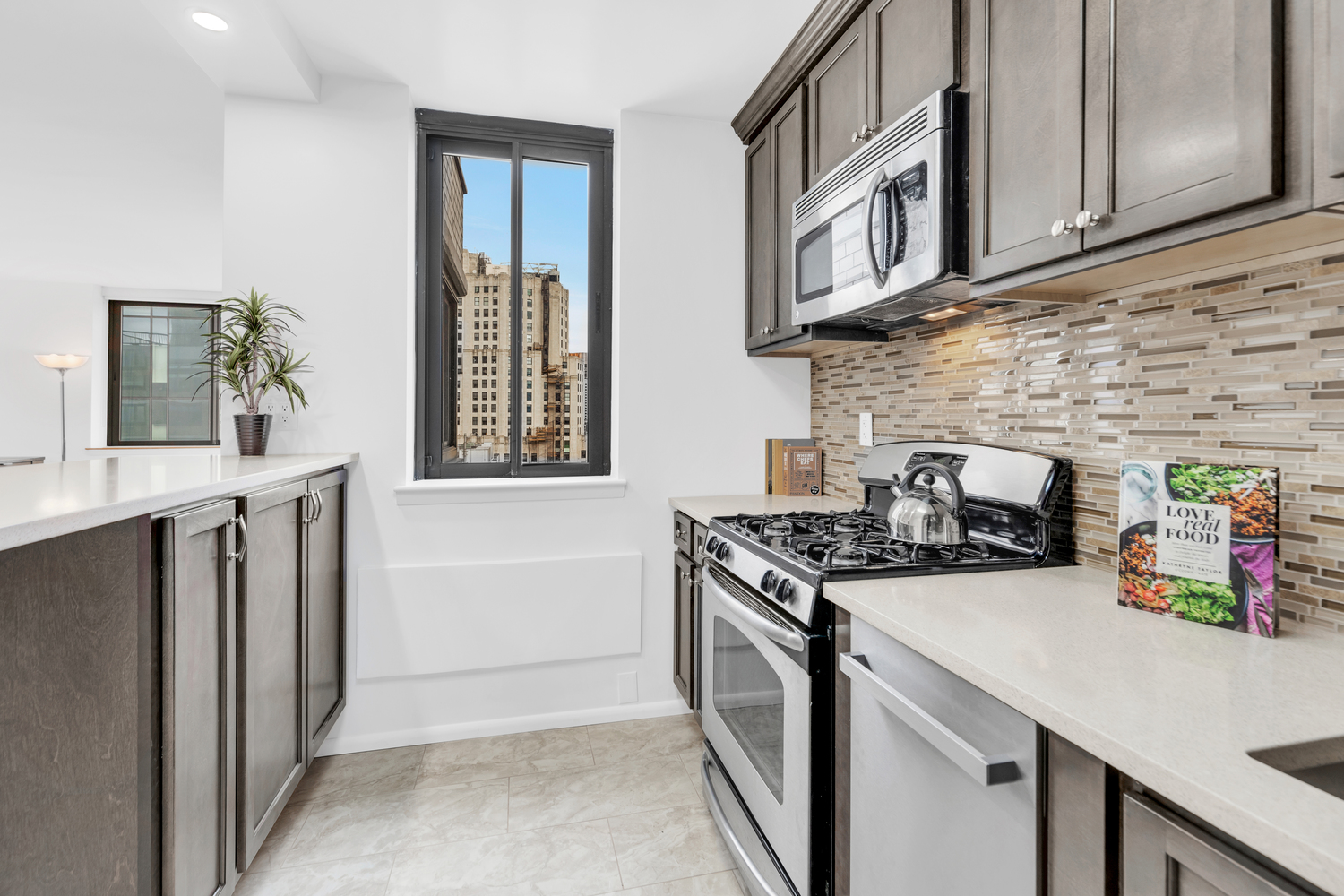 280 Park Avenue South, Unit 26M Manhattan, NY 10010 - Photo 3 of 14 a kitchen with stainless steel appliances granite countertop a stove and a sink
