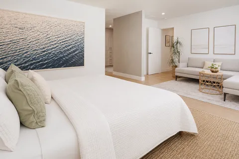 a spacious bedroom with a bed and window