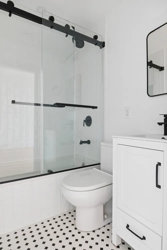 a bathroom with a toilet a sink and a shower