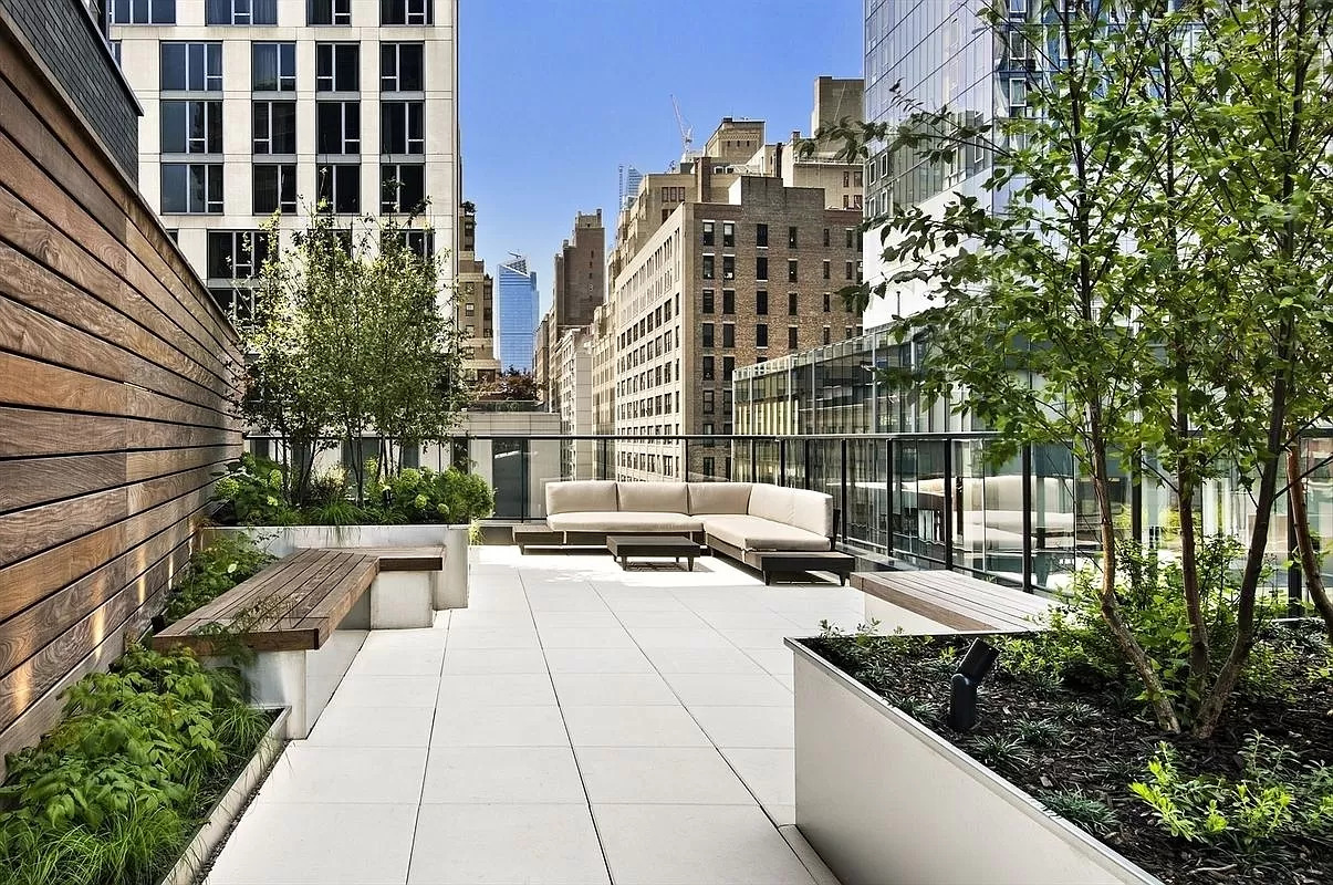 50 West 30th Street, Unit 3B Manhattan, NY 10001 - Photo 12 of 13 a terrace of a building with couches potted plants and wooden walls