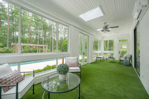 a view of a swimming pool with a patio and yard