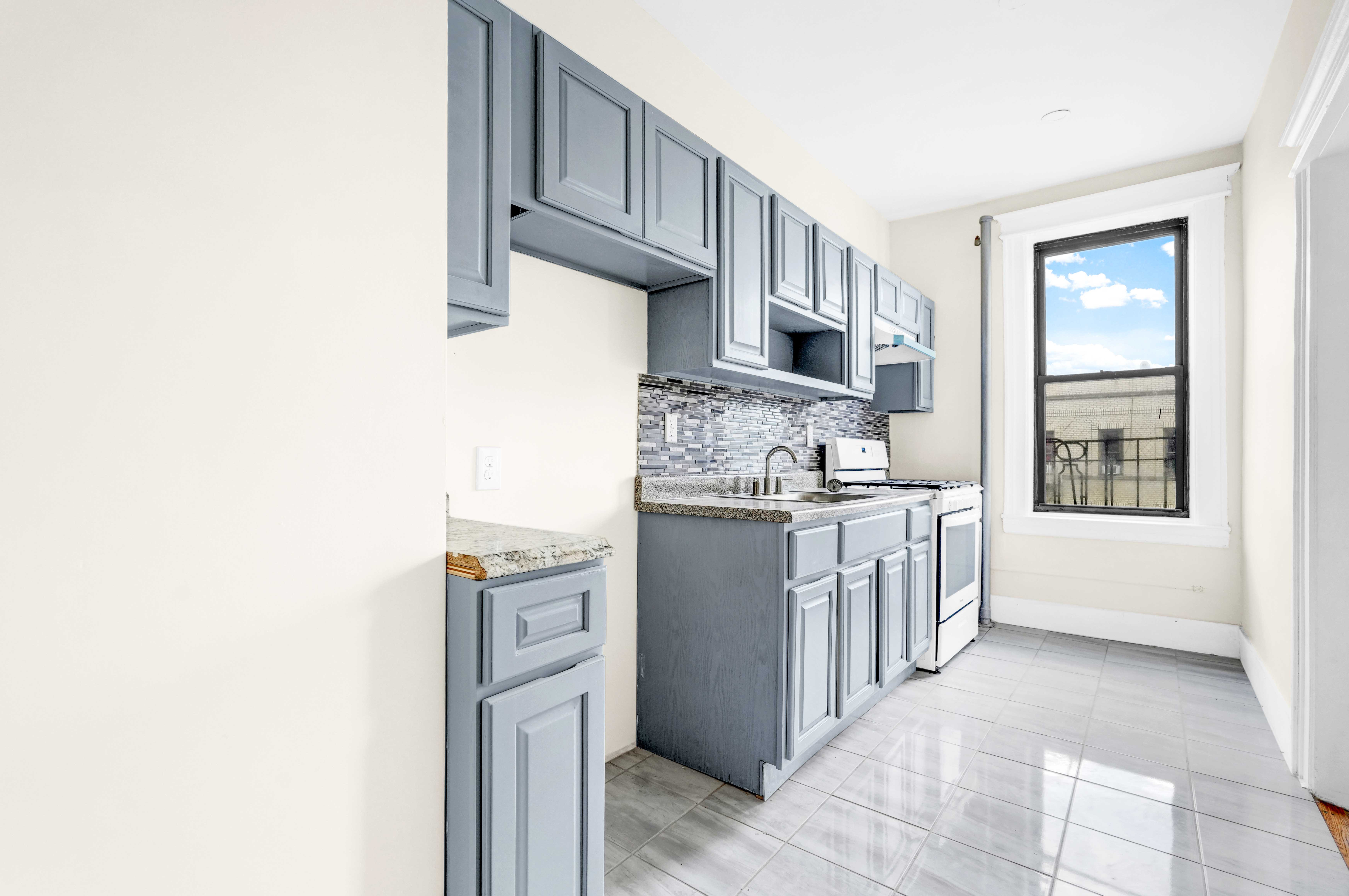 1770 Bedford Avenue Brooklyn, NY 11225 - Photo 37 of 50 a kitchen with stainless steel appliances granite countertop a stove and a refrigerator