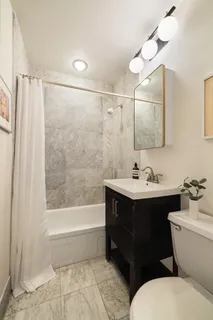 a bathroom with a sink mirror toilet and bathtub