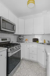 a kitchen with cabinets stainless steel appliances and a sink