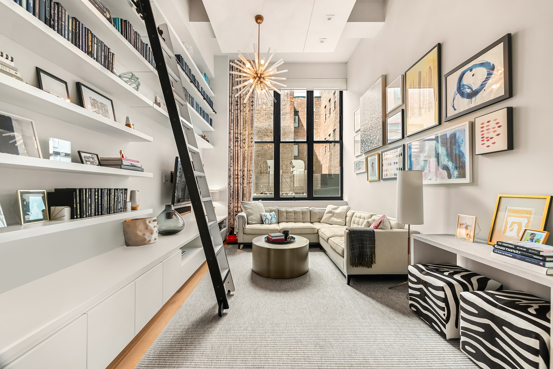 421 Hudson Street, Unit 318 Manhattan, NY 10014 - Photo 1 of 12 a bedroom with furniture and a book shelf