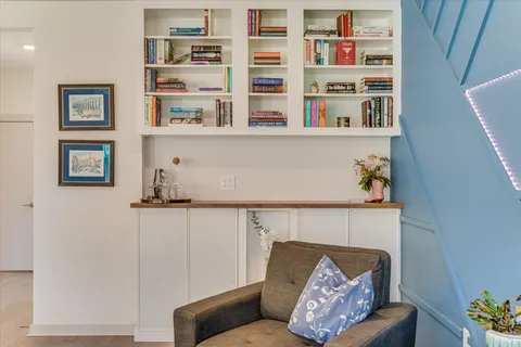 a living room with hard wood cabinets and a couch