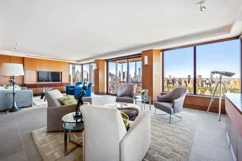 a living room with furniture and large windows