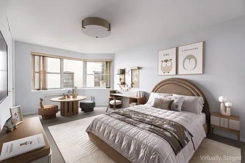 a bedroom with bed and a large window