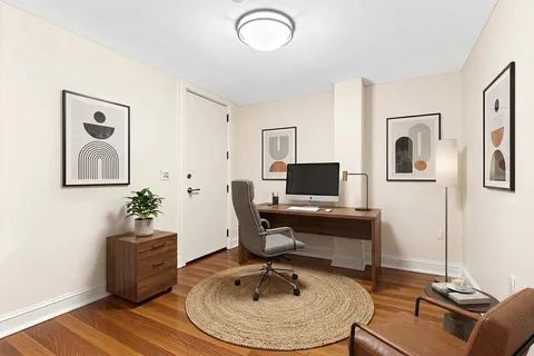 a work room with furniture and wooden floor