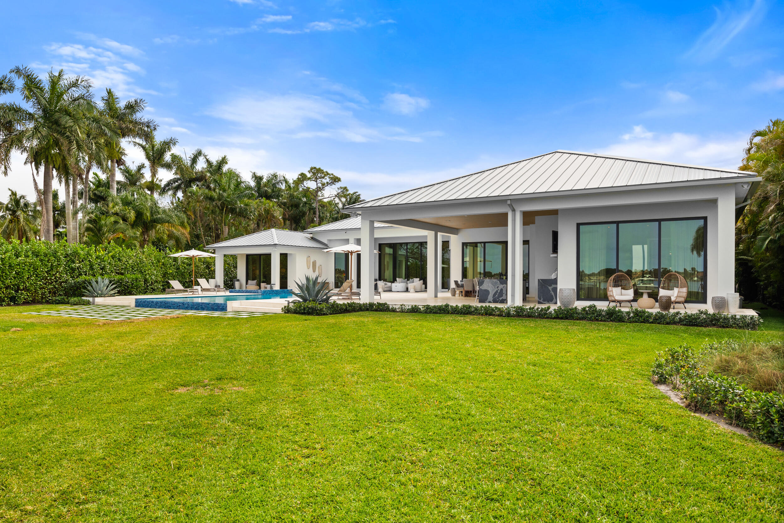 5695 Pennock Point Road Jupiter, FL 33458 - Photo 76 of 77 a front view of a house with swimming pool having outdoor seating