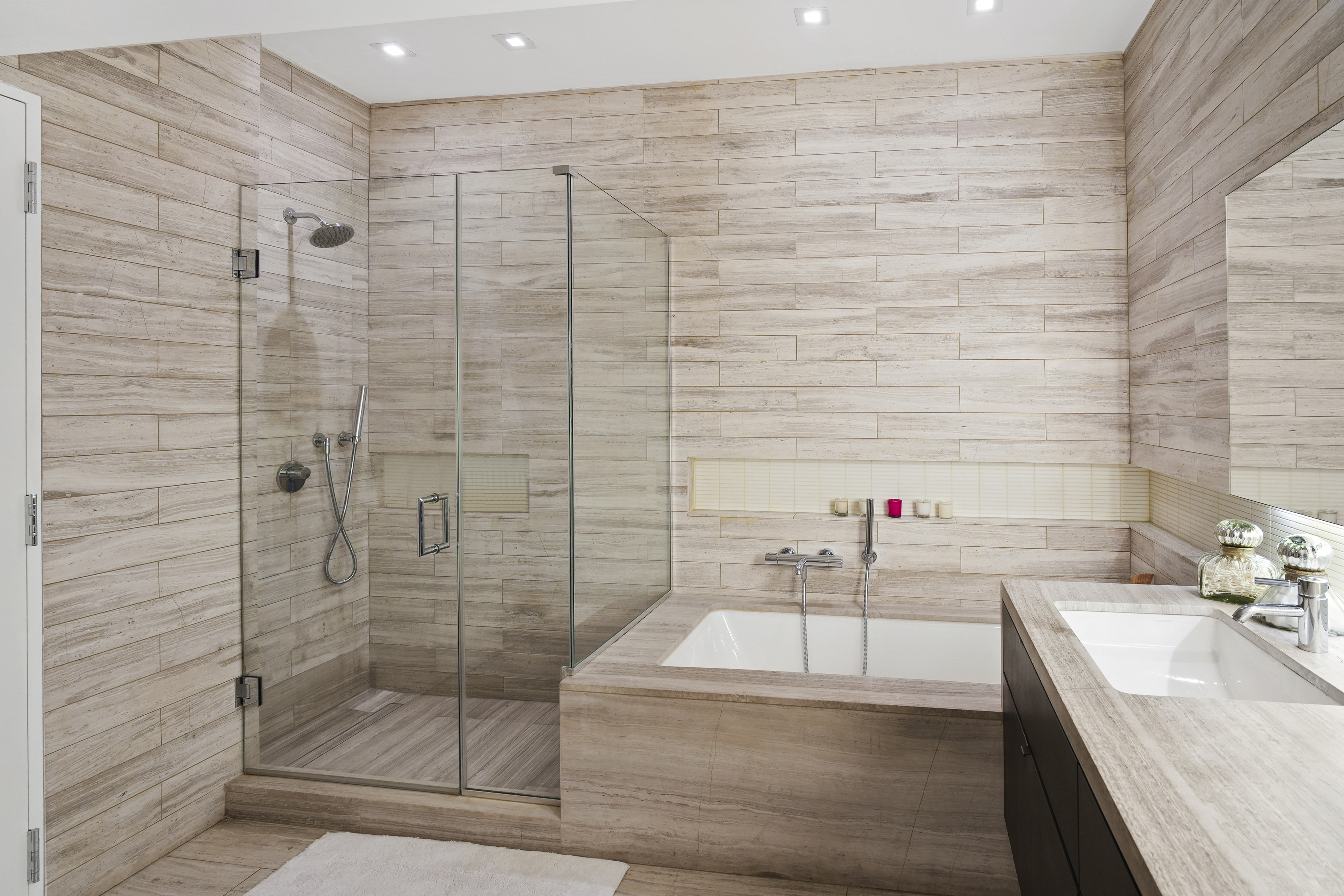 421 Hudson Street, Unit 221 Manhattan, NY 10014 - Photo 7 of 12 a bathroom with a granite countertop sink a shower and a mirror