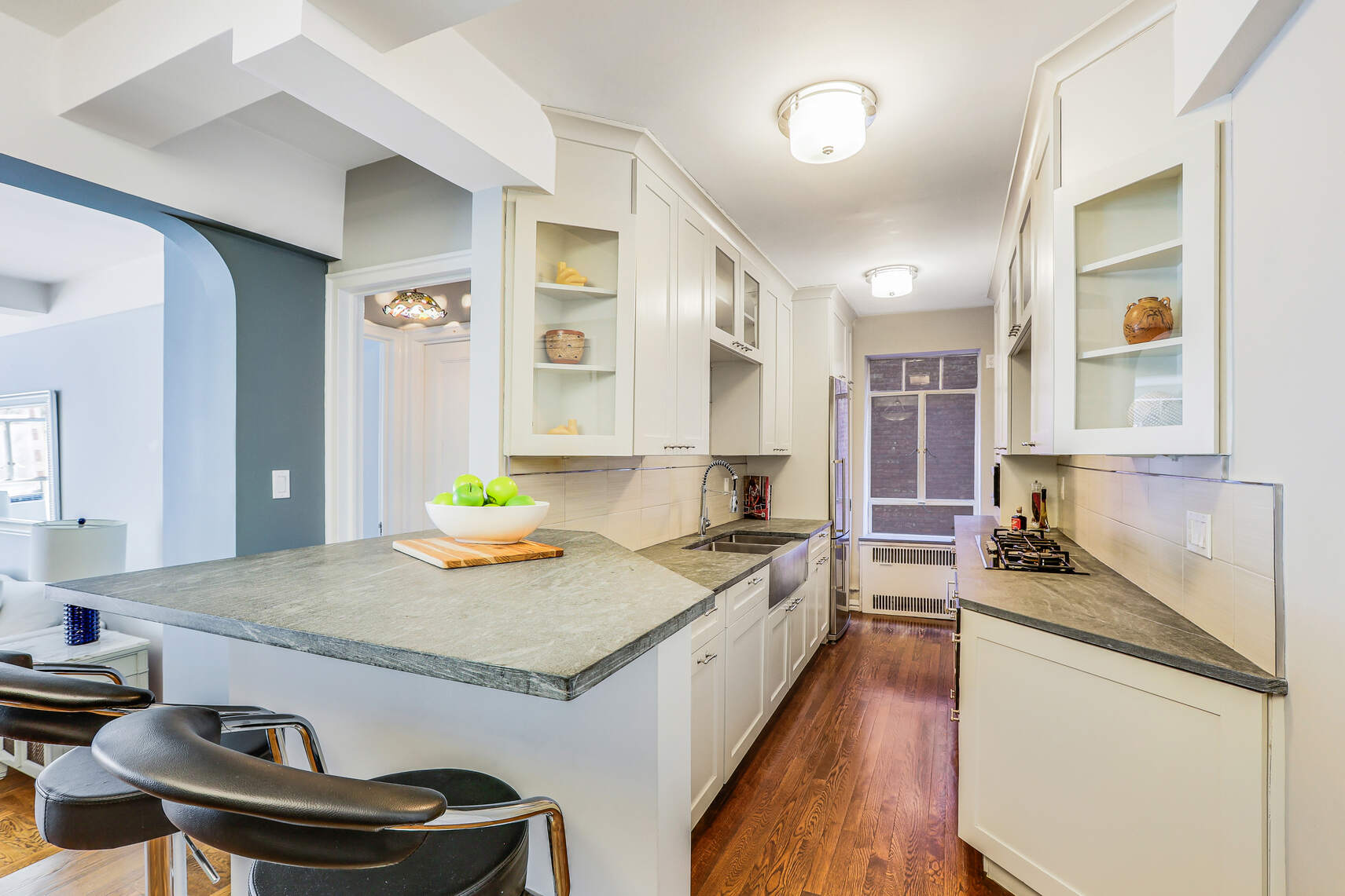 565 West End Avenue, Unit 3C Manhattan, NY 10024 - Photo 7 of 15 a kitchen with granite countertop a sink stove and cabinets