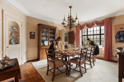 a view of a dining room with furniture and chandelier