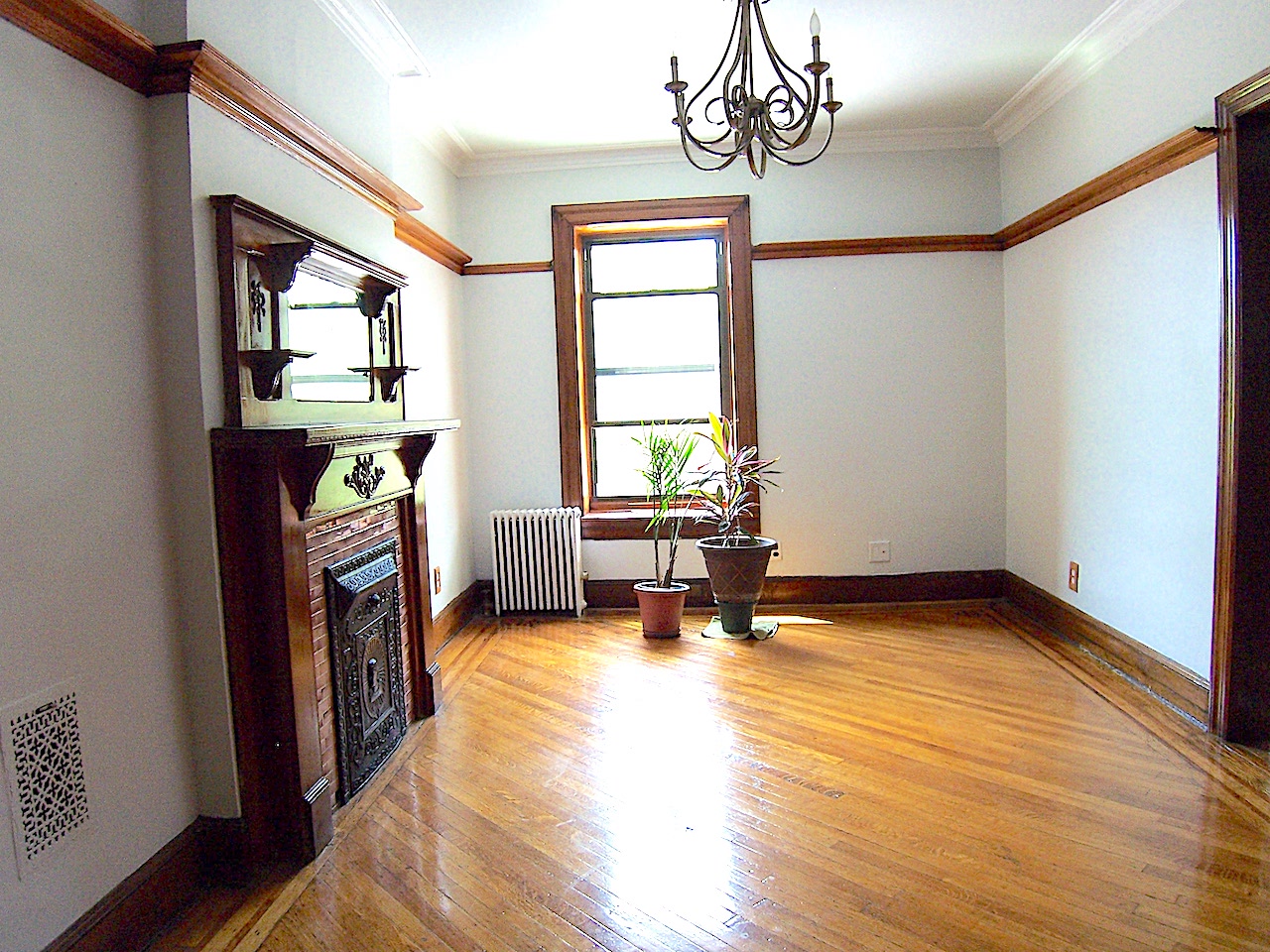 864 Prospect Place, Unit 2 Brooklyn, NY 11216 - Photo 3 of 6 a view of an empty room with a window and wooden floor