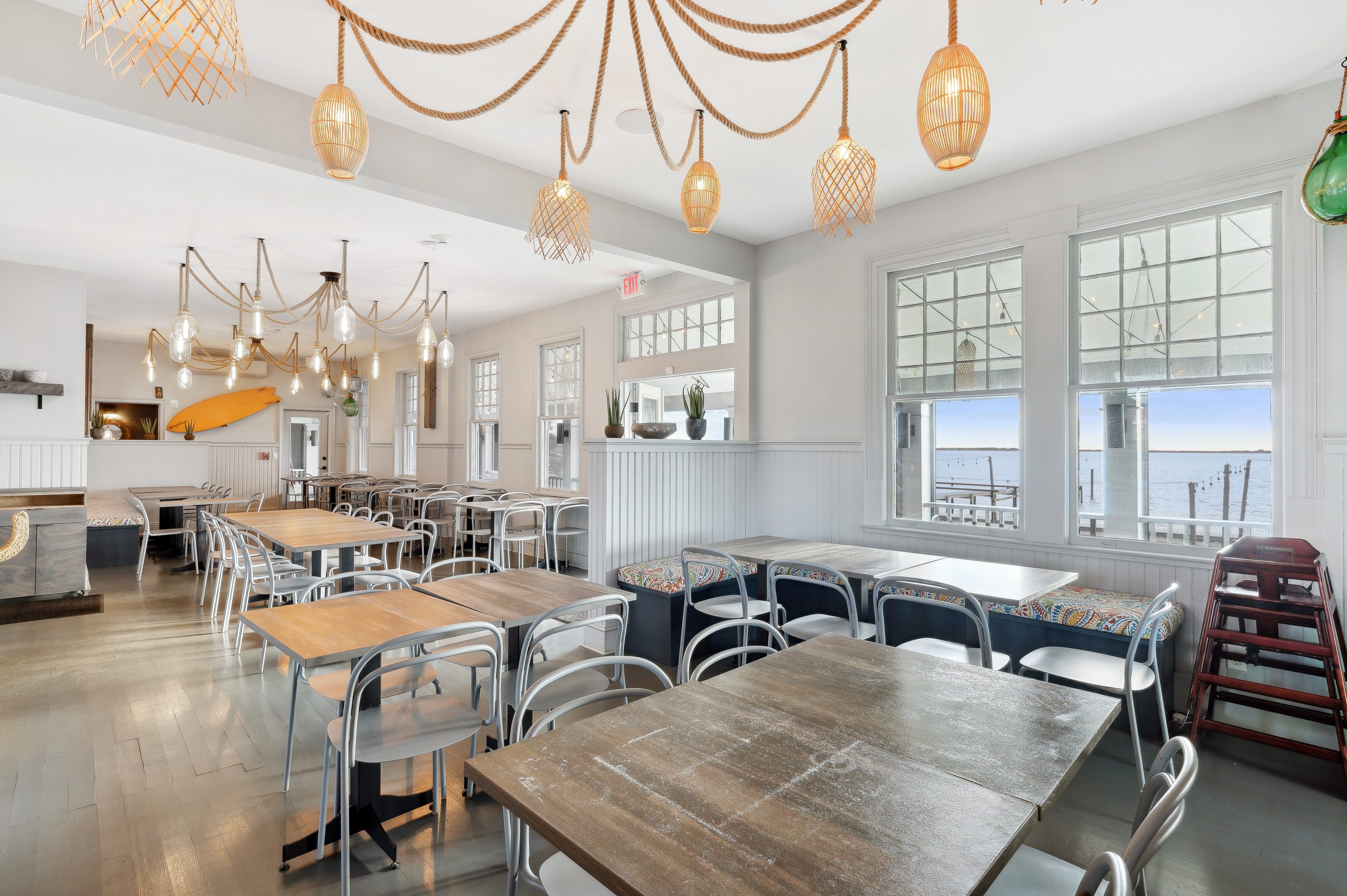 32 Lighthouse Road Hampton Bays, NY 11946 - Photo 19 of 51 a living room with lots of furniture and a chandelier