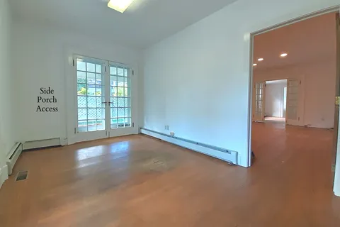 wooden floor in an empty room with a window