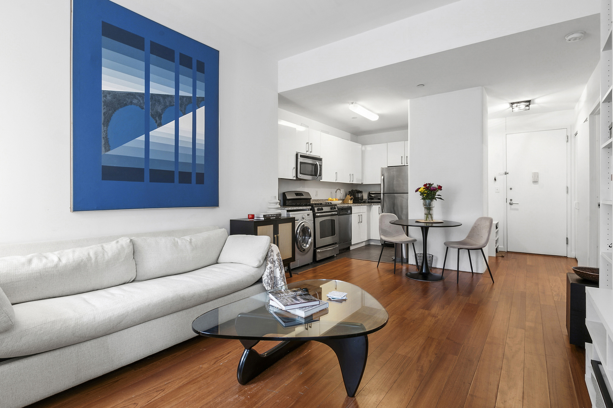 184 Kent Avenue, Unit D101 Brooklyn, NY 11249 - Photo 2 of 8 a living room with furniture and wooden floor