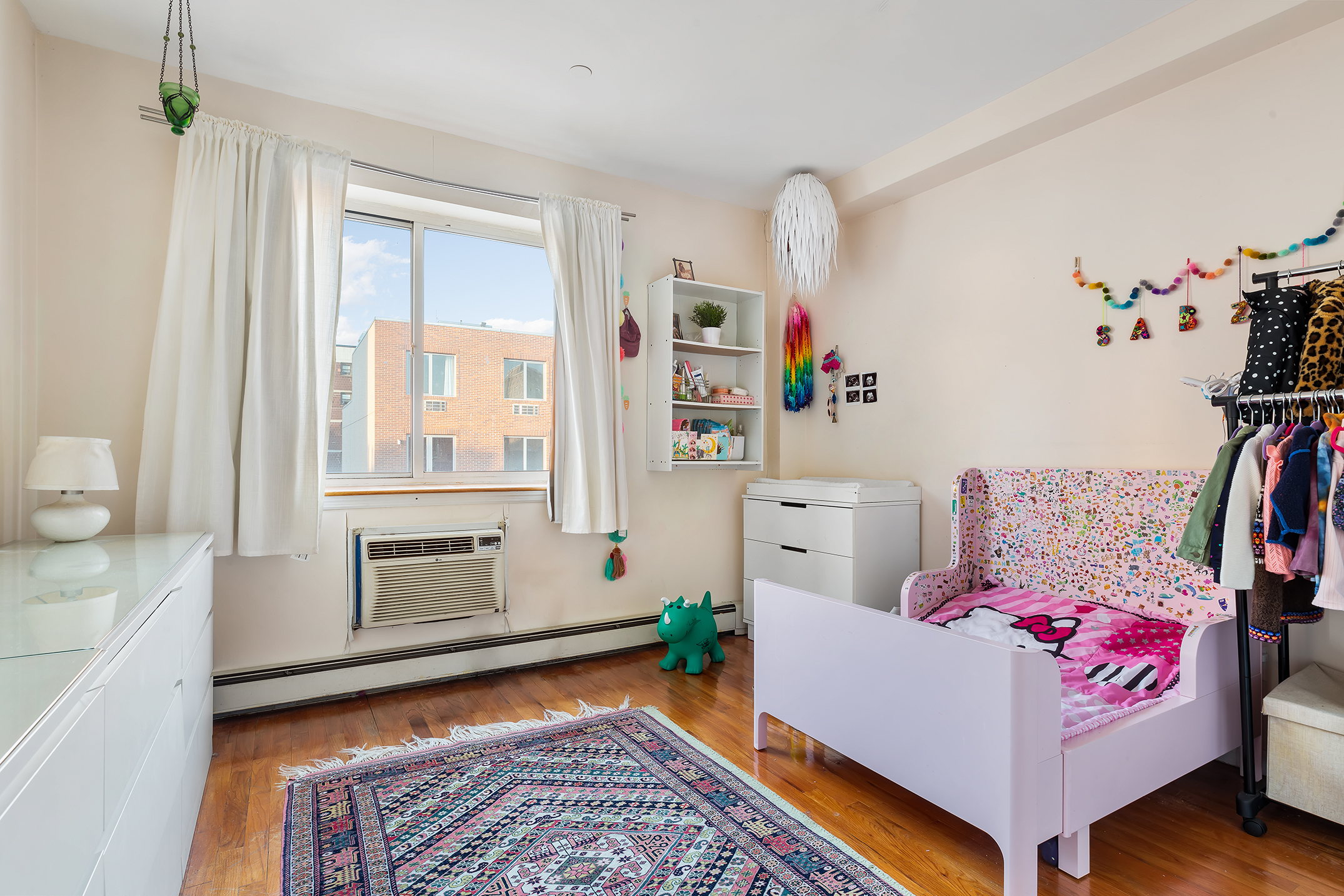 97 Moore Street, Unit 4B Brooklyn, NY 11206 - Photo 5 of 8 a living room with furniture and a window