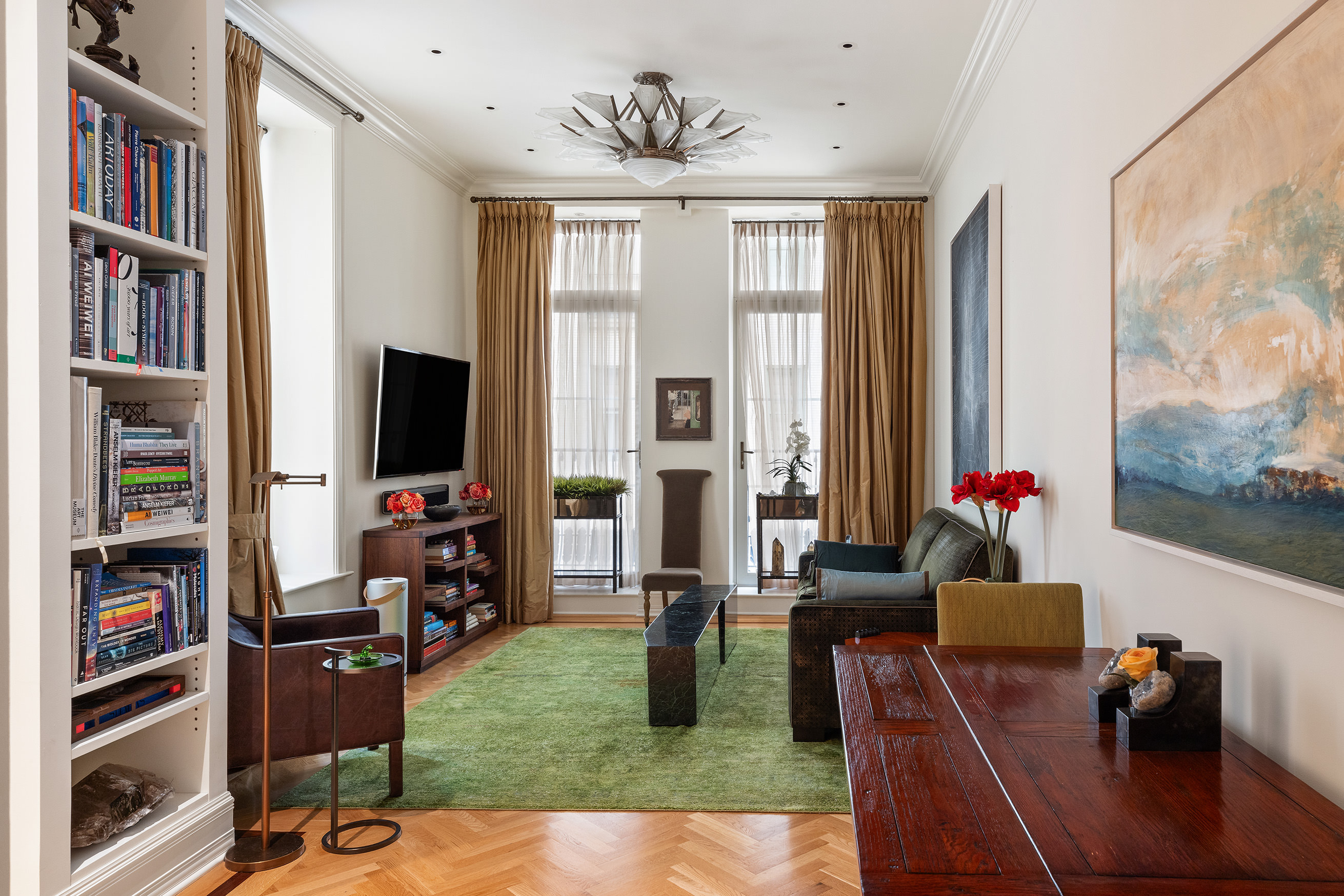 1 Central Park South, Unit 802 Manhattan, NY 10019 - Photo 1 of 16 a living room with furniture and a flat screen tv