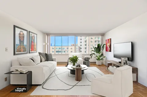 a living room with furniture a flat screen tv and a window