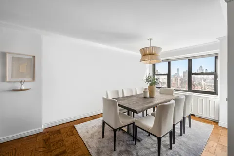 a dining room with furniture and window