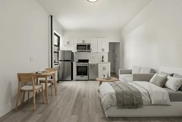 a spacious bedroom with a bed and furniture