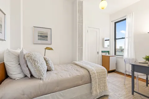 a bedroom with a bed and a table