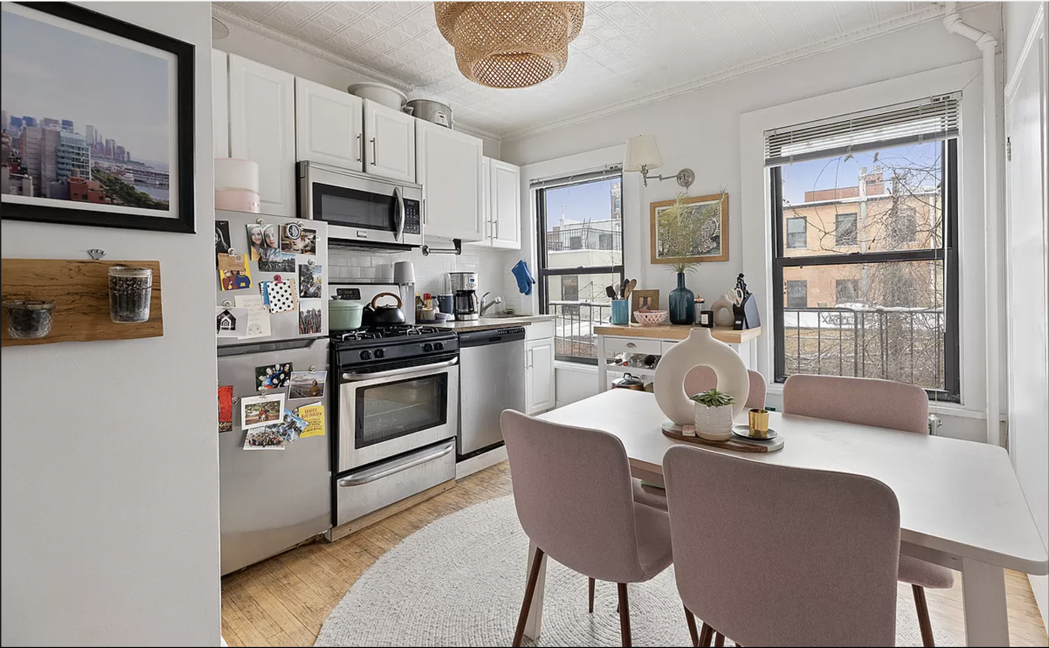 26 Fillmore Place, Unit 2 Brooklyn, NY 11211 - Photo 2 of 5 a kitchen with stainless steel appliances granite countertop a stove a sink a microwave and a refrigerator