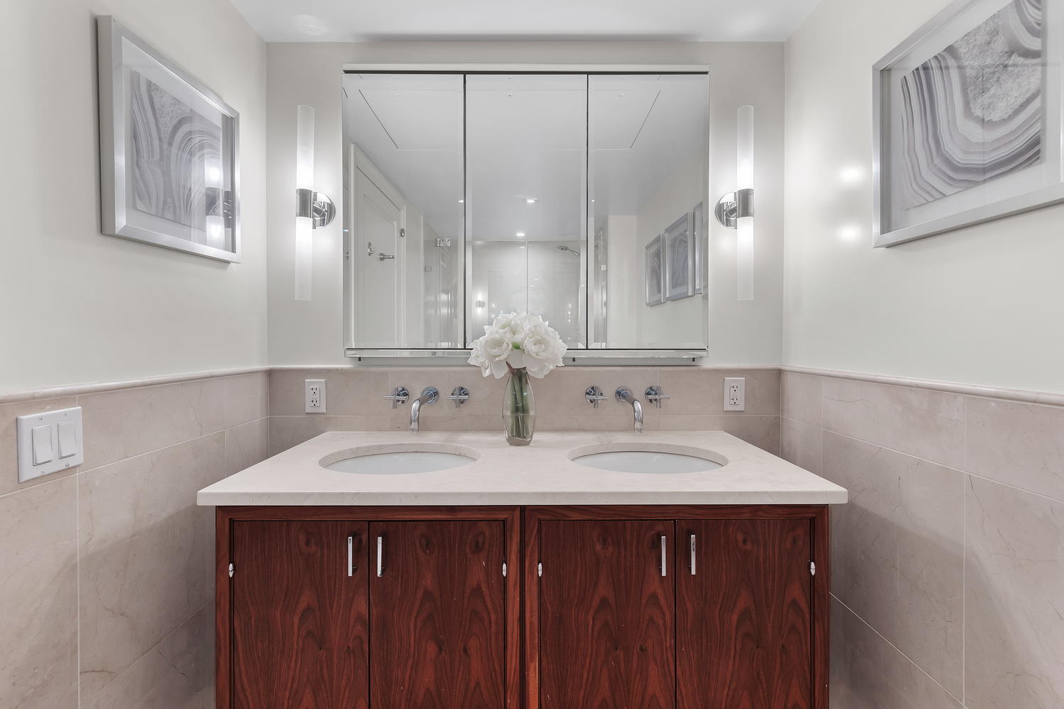 200 East 66th Street, Unit A407 Manhattan, NY 10065 - Photo 9 of 24 a bathroom with a sink and a mirror