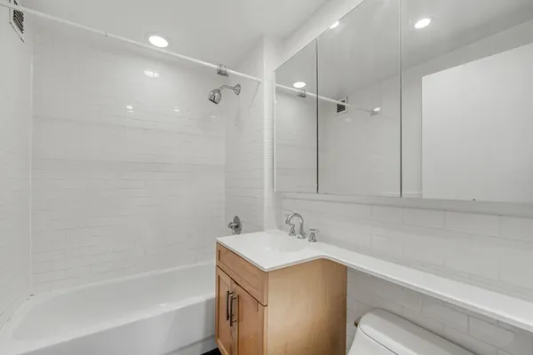 a bathroom with a bathtub and a sink