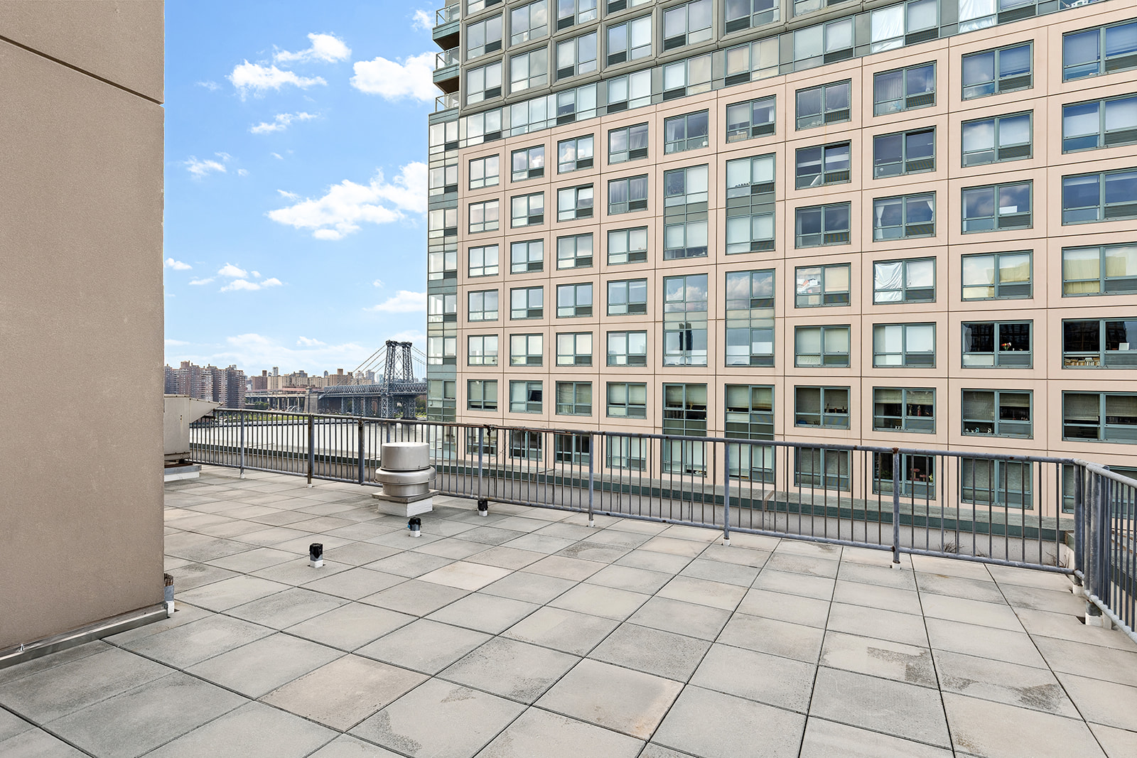 446 Kent Avenue, Unit PHC Brooklyn, NY 11249 - Photo 20 of 22 a building with a bench in front of it