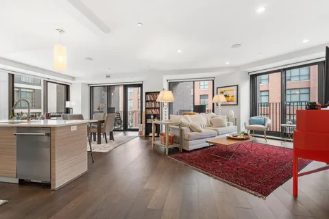 a living room with furniture rug and window