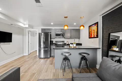 a kitchen with stainless steel appliances a refrigerator and a stove top oven
