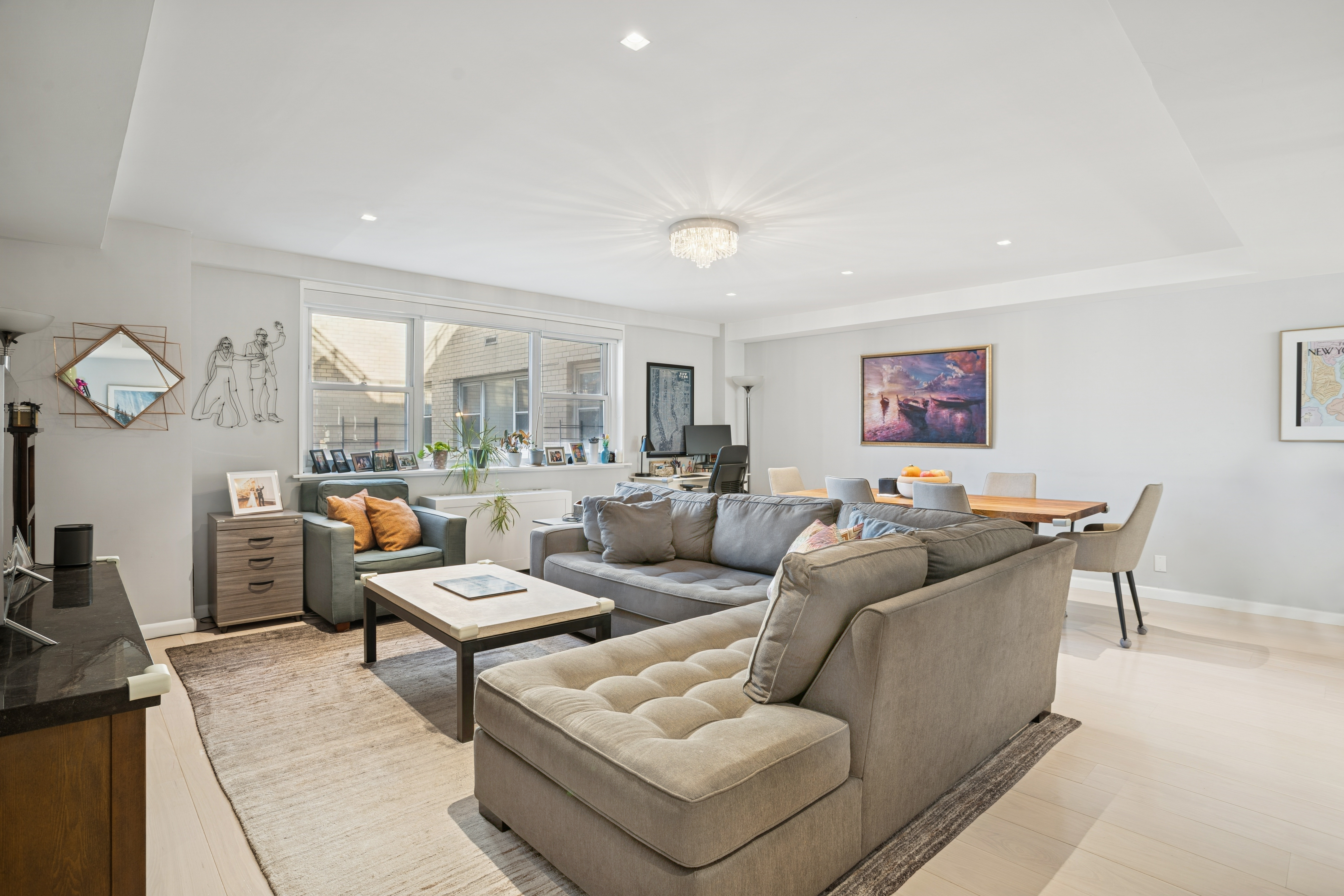 345 East 56th Street, Unit 21F Manhattan, NY 10022 - Photo 2 of 15 a living room with furniture and a large window