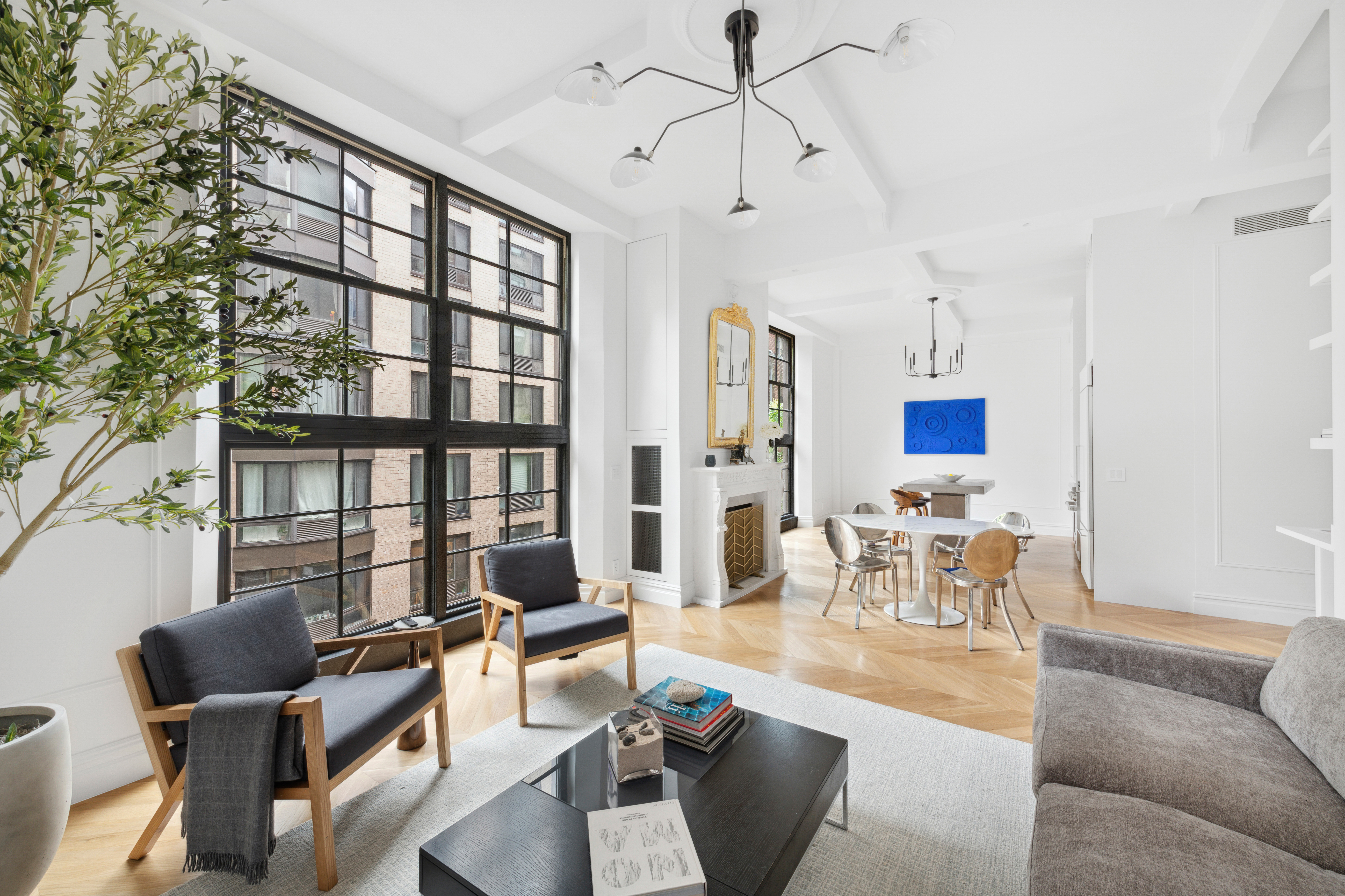 33 West 67th Street, Unit 4M Manhattan, NY 10023 - Photo 3 of 16 a living room with furniture or couch and a chandelier