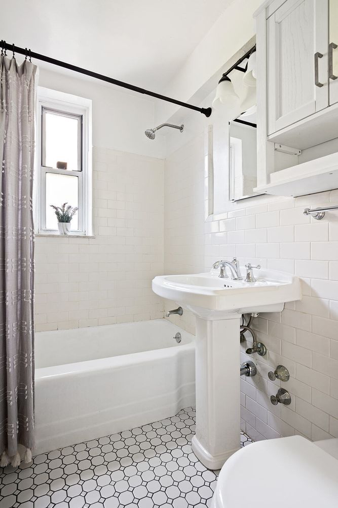 302 East 88th Street, Unit 3F Manhattan, NY 10128 - Photo 5 of 6 a bathroom with a sink a toilet and shower