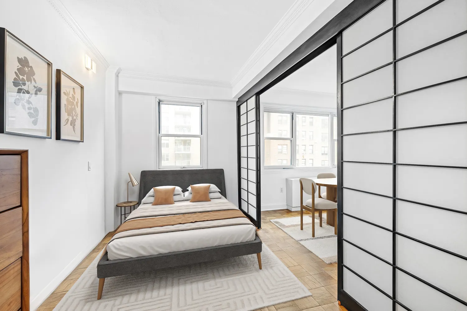 a bedroom with a bed and a large window