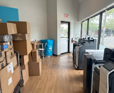 a view of a workspace with furniture and a kitchen