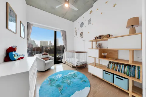a living room with furniture and a book shelf
