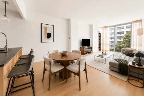 a view of a livingroom with furniture and a window