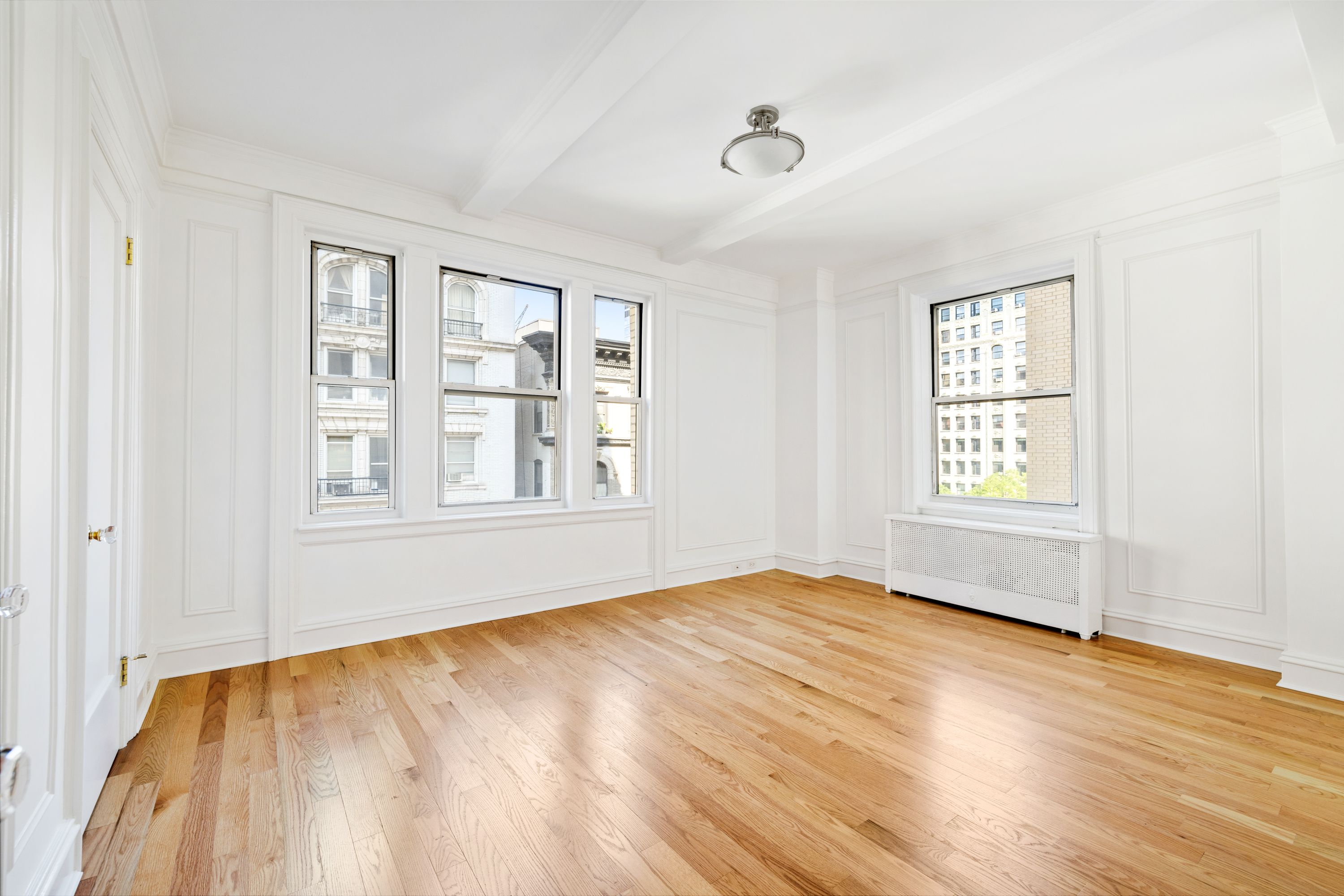 240 West 98th Street, Unit 7D Manhattan, NY 10025 - Photo 11 of 14 a view of an empty room with wooden floor and a window