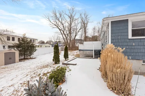a view of a house with snow on the road